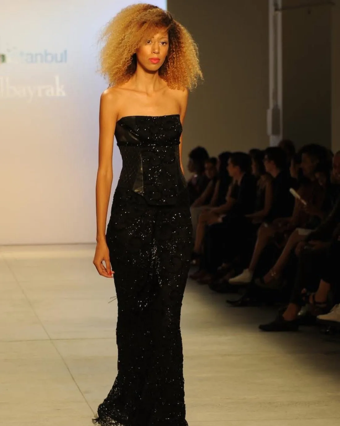 Model Gaby on the runway with voluminous honey-blonde curls styled by Ayfer Deniz